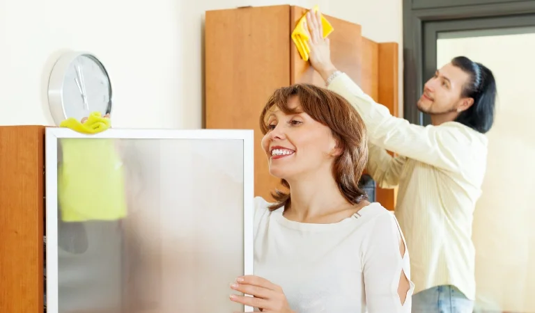 A couple is performing house cleaning.