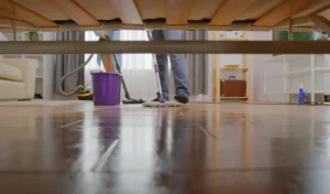 Washing with a mop in the house, view from under the sofa