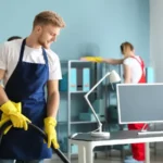 Team of janitors cleaning office