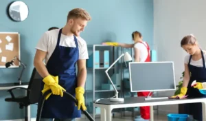 Team of janitors cleaning office