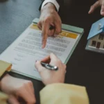 Real estate agent is explaining details of home contract